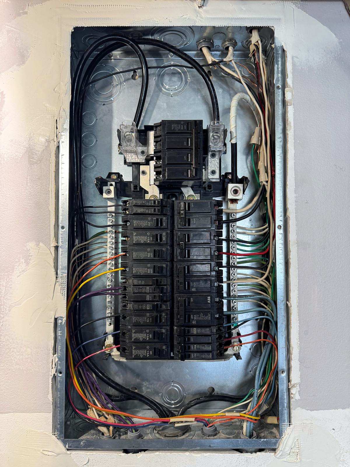 Inside a new panel: breakers in two rows and circuit wires routed neatly along both sides