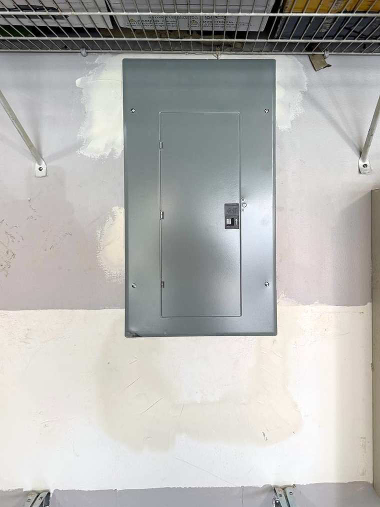 The same garage wall with the new panel closed behind its cover
