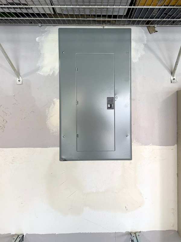 The same garage wall with the new panel closed behind its cover