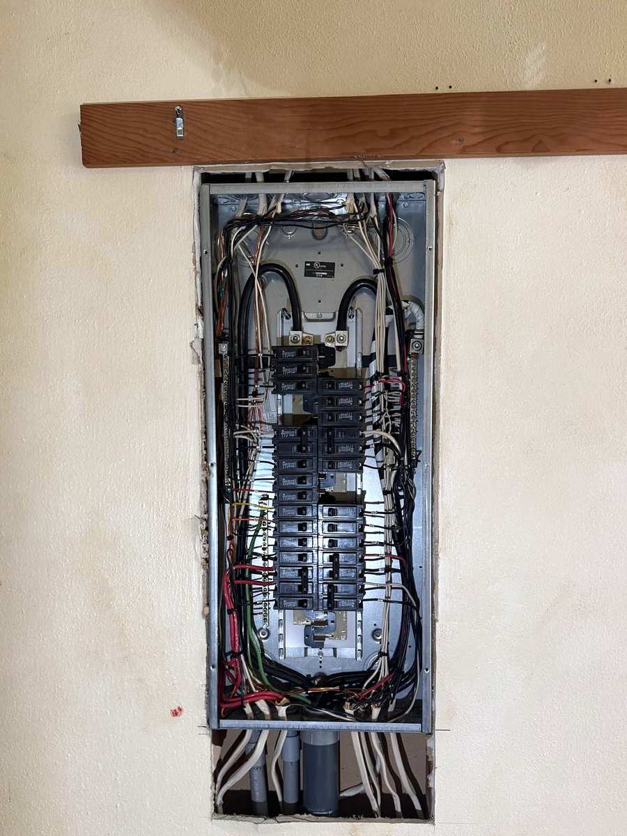 The same panel with breakers installed and the circuit wiring connected and routed