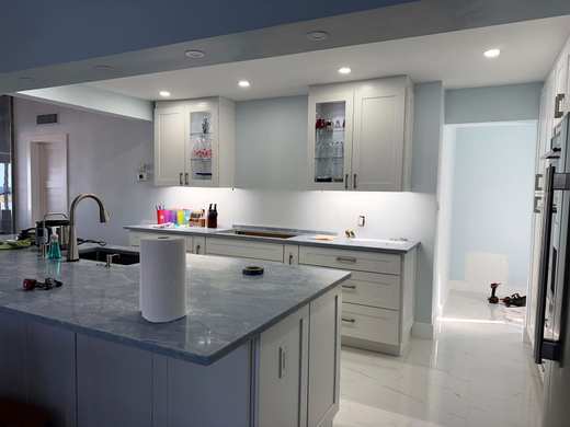 Kitchen with recessed ceiling lights and under-cabinet lighting over the counters